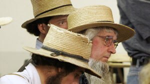 Amish men react to news of a school shooting near Lancaster, Pennsylvania.