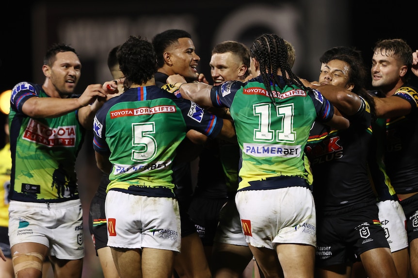 Stephen Crichton of the Penrith Panthers is at the center of a melee with Canberra Raiders players during an NRL game.