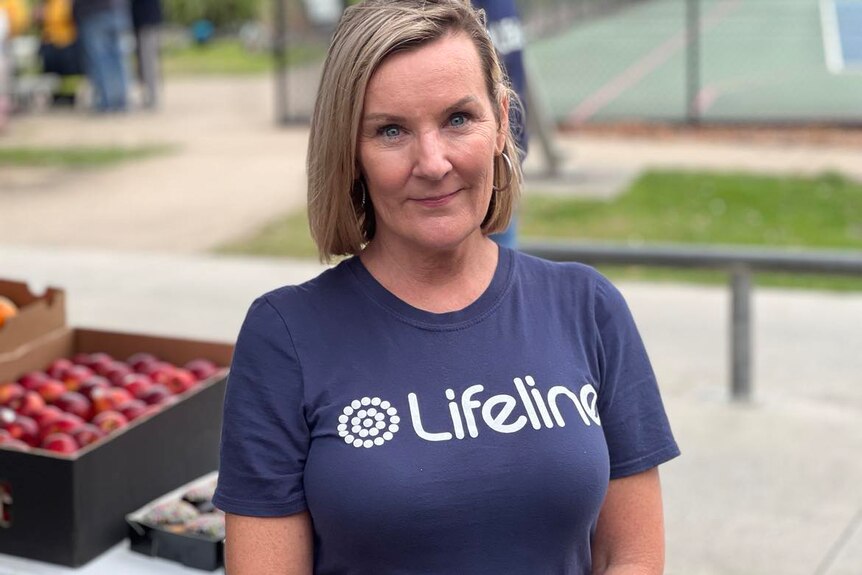 A woman with blond hair wearing a blue Lifeline T-shirt.