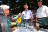 Composite image showing former prime minister Malcolm Turnbull being berated by a voter in a beer garden.