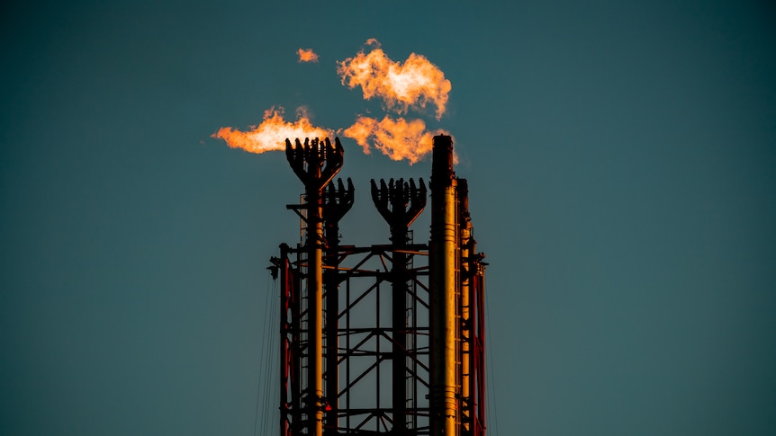 Chimneys from Scarborough's Pluto gas facility with flames coming from them.