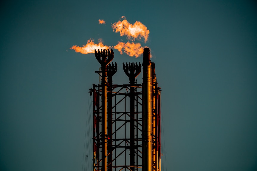 Chimneys from Scarborough's Pluto gas facility with flames coming from them.