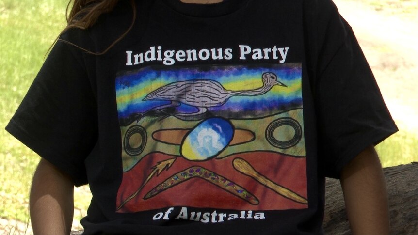 A young girl wearing a tshirt with the works 'Indigenous Party of Australia' on it