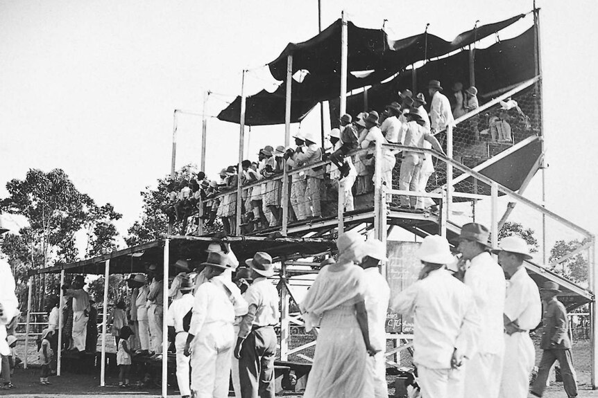 Black and white image of people at the races