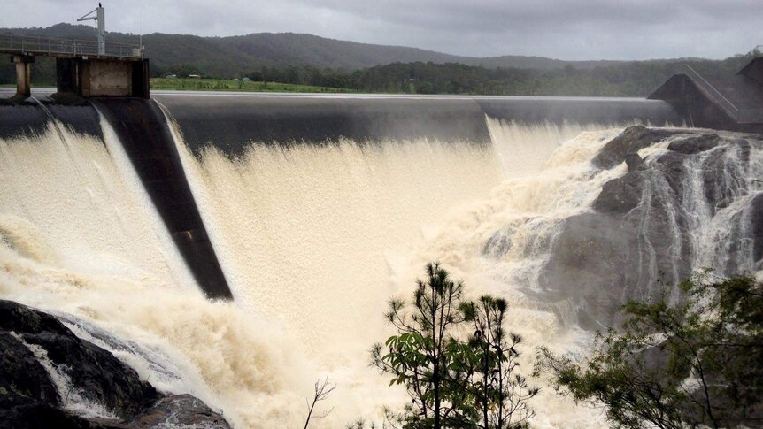 Water pours over the wall of Wappa Dam.