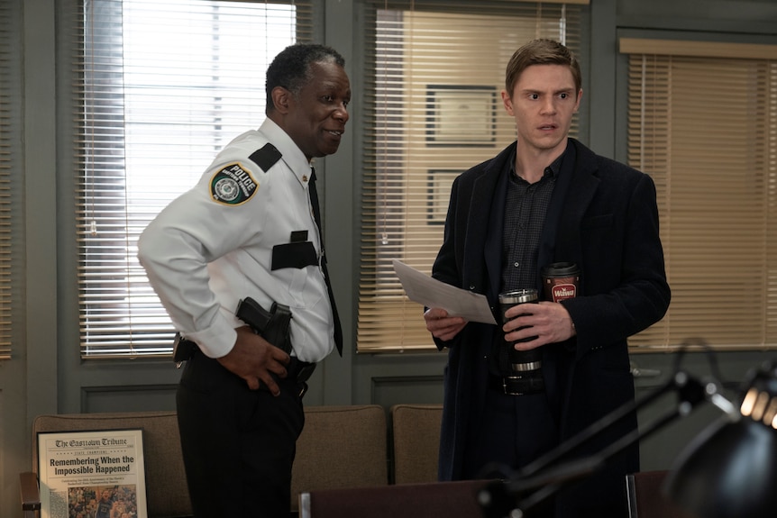 John Douglas Thompson and Evan Peters, a police chief and detective in a police station, in tv series Mare of Easttown