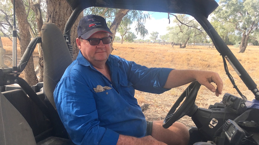Grazier Justin McClure sits in his all terrain vehicle on his western New South Wales property.