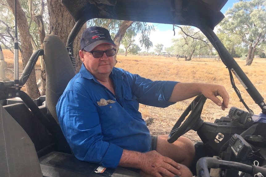 Grazier Justin McClure sits in his all terrain vehicle on his western New South Wales property.