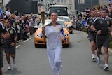 An Olympic torch bearer carries the torch through Newquay in south-west England.