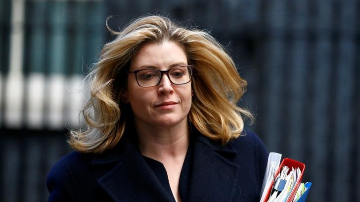 Penny Mordaunt sports a slight smile as her hair blows in the wind while leaving 10 Downing Street