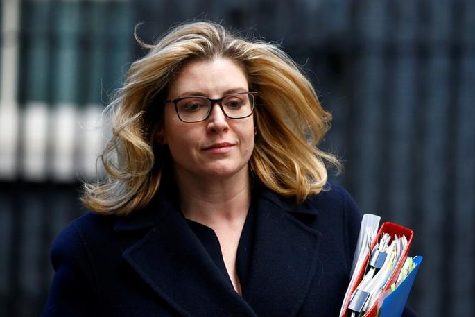 Penny Mordaunt sports a slight smile as her hair blows in the wind while leaving 10 Downing Street