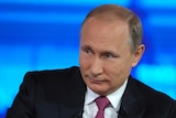 Russian President Vladimir Putin listens during a TV interview.