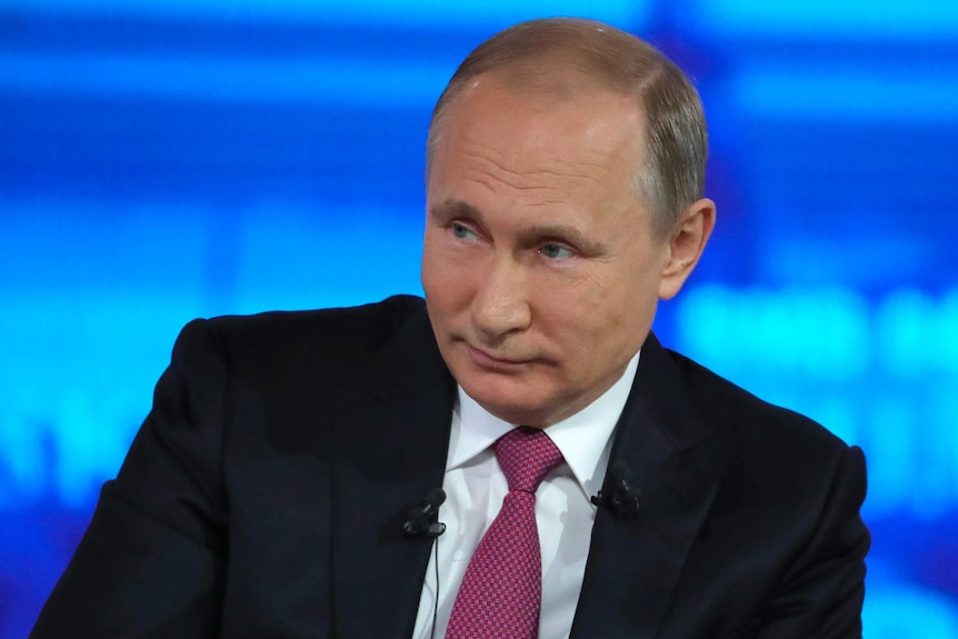 Russian President Vladimir Putin listens during a TV interview.