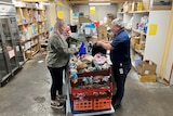 woman and man at charity organising food donations 