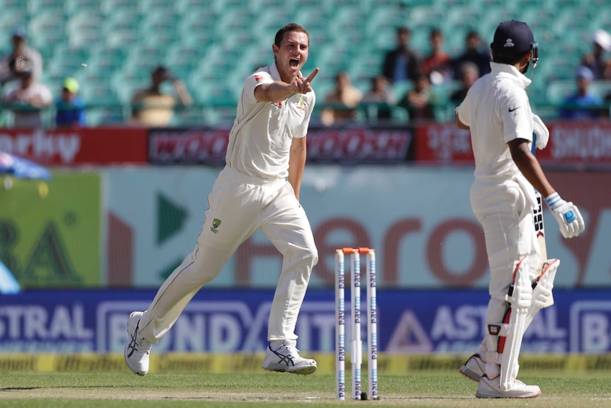 Australia's Josh Hazlewood celebrates the wicket of India's Murali Vijay