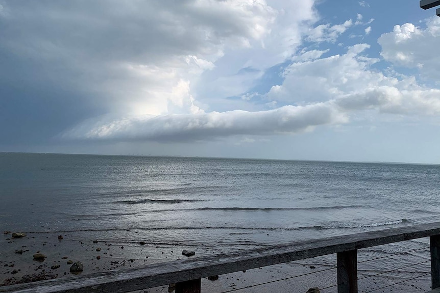 Storm clouds and rain roll in off Woody Point, north of Brisbane on November 5, 2020