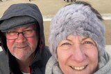 David and Maree Roberts selfie in front of scenery in France. 