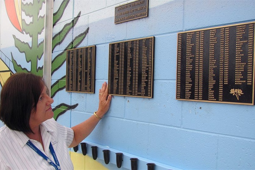 Curator Mandy Rose with the memorial plaques
