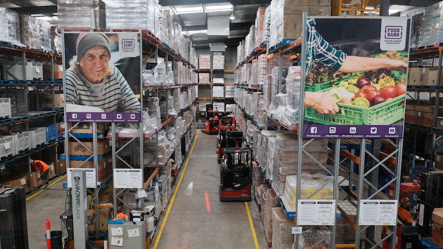 The floor of a foodbank warehouse with shelves of food