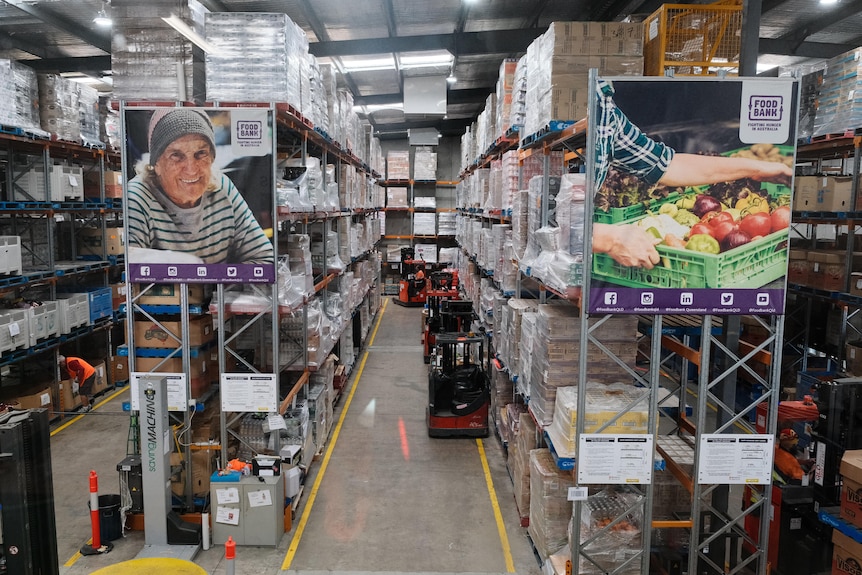 The floor of a foodbank warehouse with shelves of food