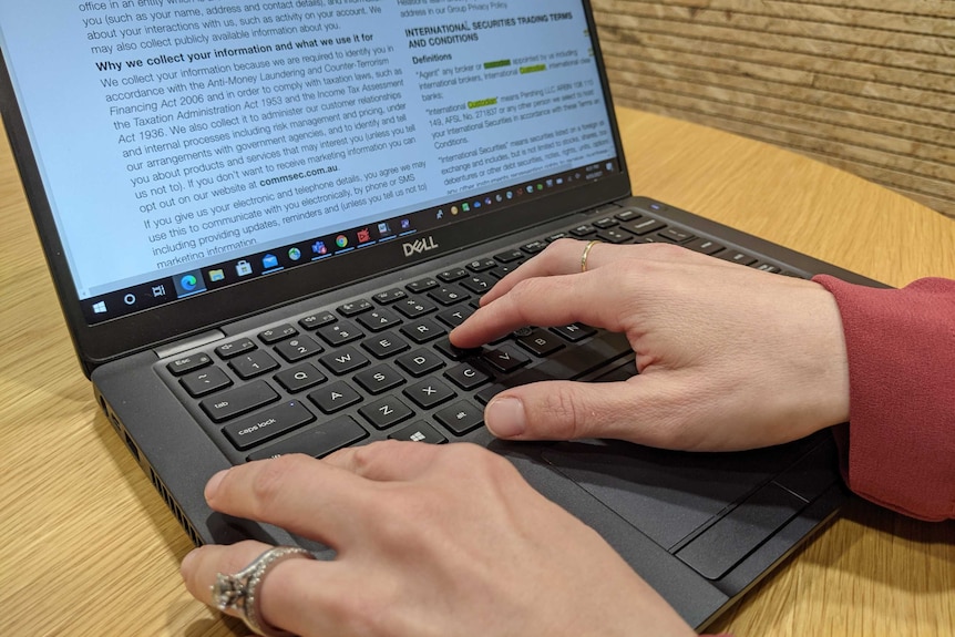 A woman's hands hit "control f" on a laptop keyboard as she searches a product disclosure statement PDF.