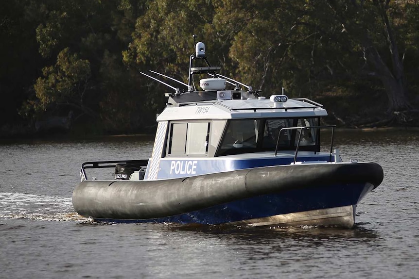 A water police boat sails on the Swan River.