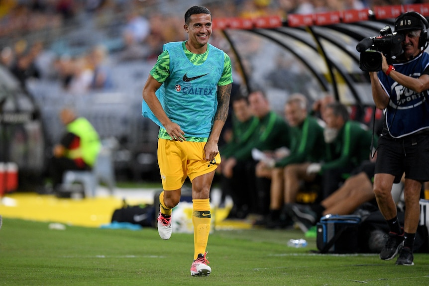 Tim Cahill smiles as he warms up for Socceroos