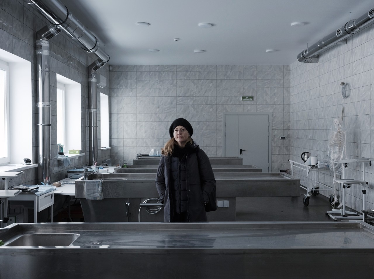 A woman looking at the camera with a neutral expression, pictured inside a laboratory.