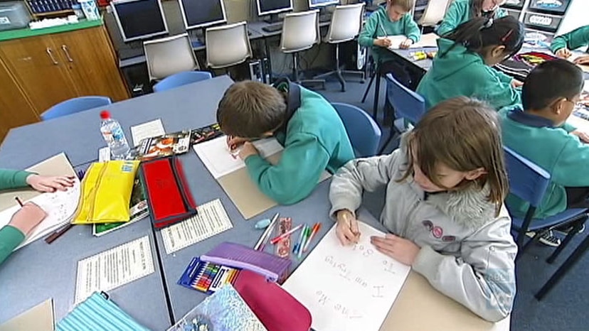 Primary school students working at a desk