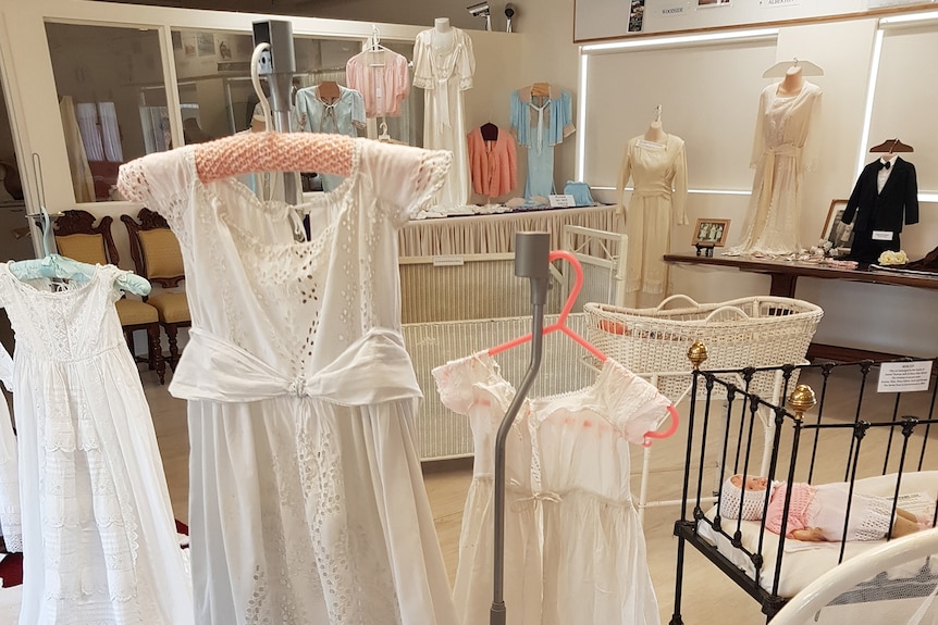 a display of white nighties and christening gowns. 