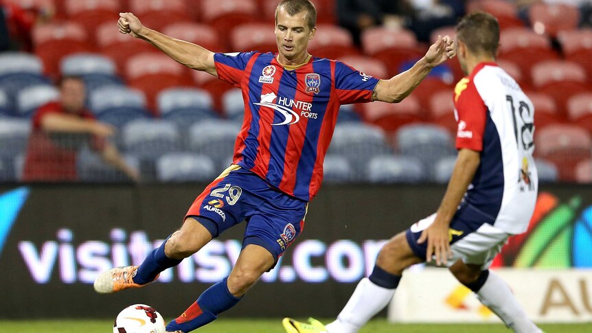 Newcastle's Joel Griffiths controls the ball against Adelaide.
