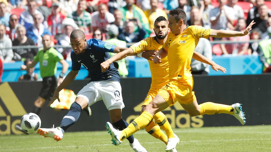 Kylian Mbappe takes a shot against the Socceroos