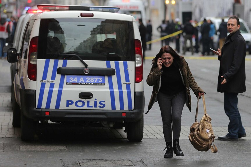 A woman reacts following a suicide bombing in Istanbul