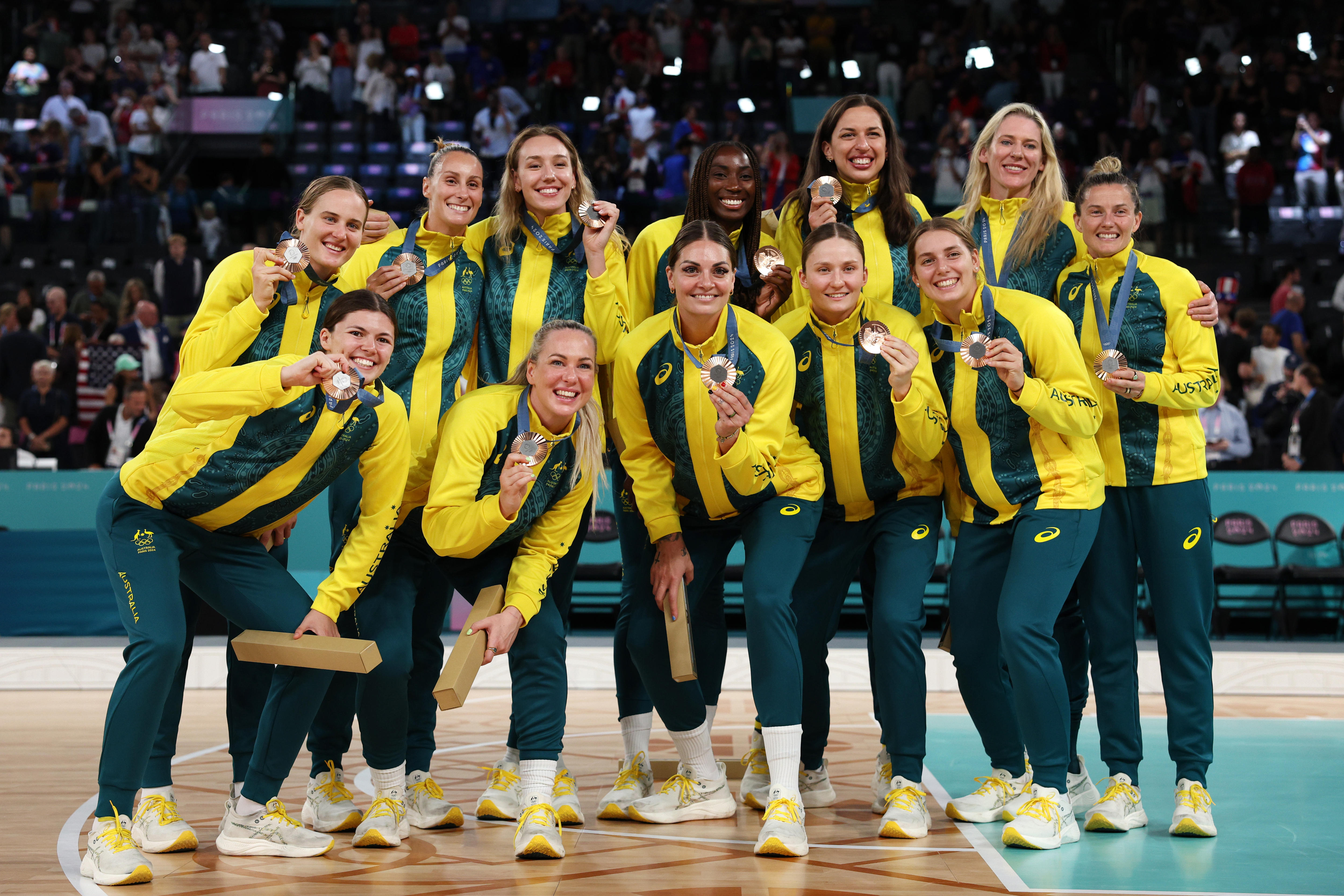The Opals players pose with their Olympic bronze medals in Paris