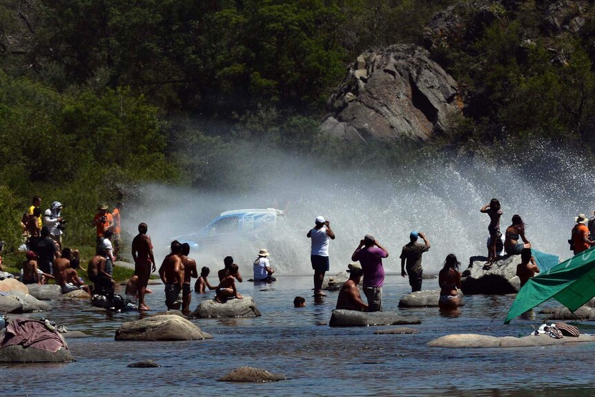 Dakar driver crosses a river