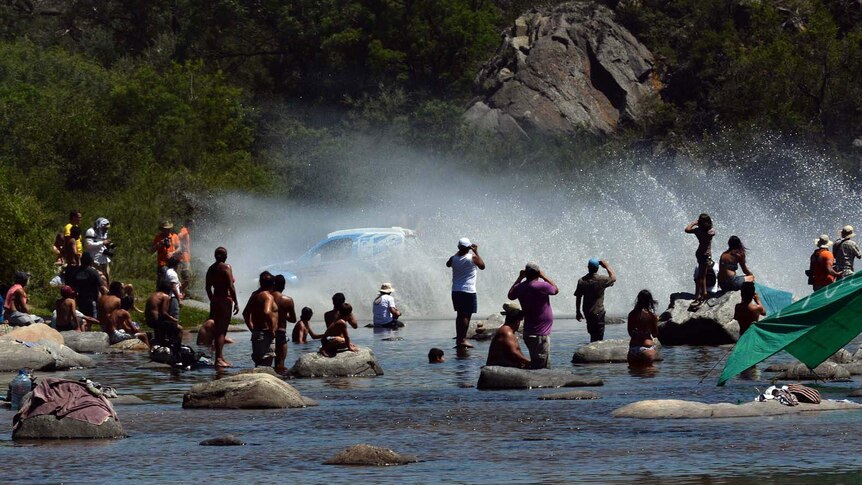 Dakar driver crosses a river