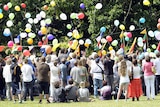 Mourners release balloons at Jai Morcom's funeral