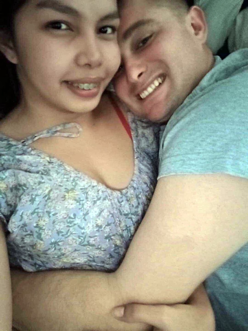 A man and woman pose for a selfie.