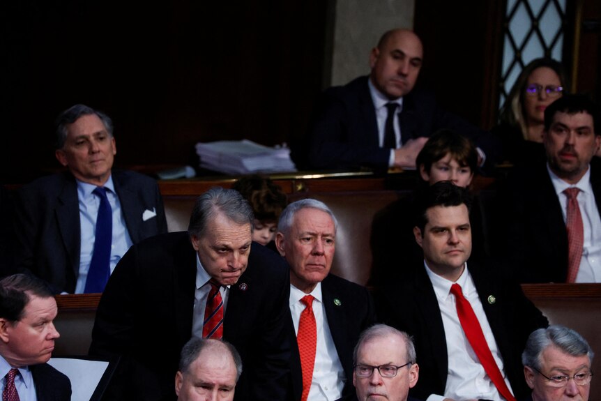 Men in suits sitting in the US House chamber