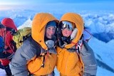 Gabby and her mother pose smiling on the summit of Mount Everest.