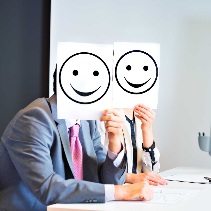 Business team holding happy smile sign