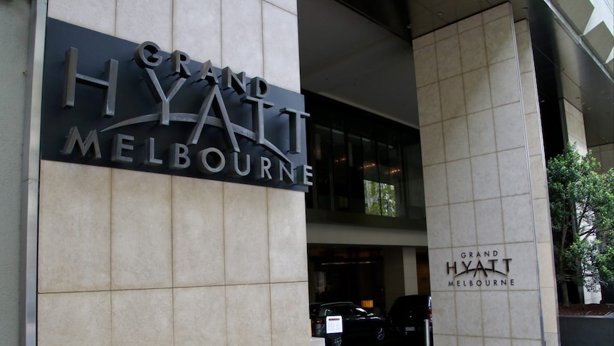 The exterior of a hotel with signage saying Grand Hyatt Melbourne.