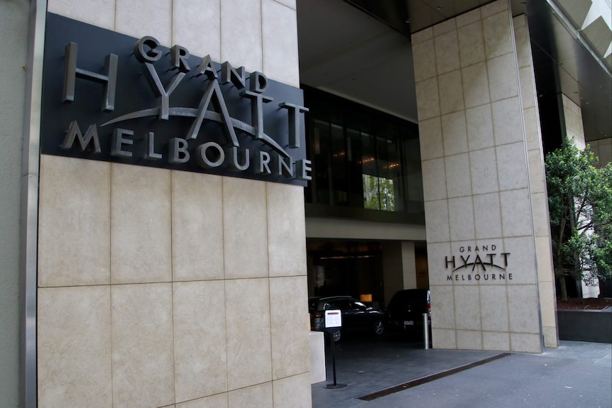 The exterior of a hotel with signage saying Grand Hyatt Melbourne.