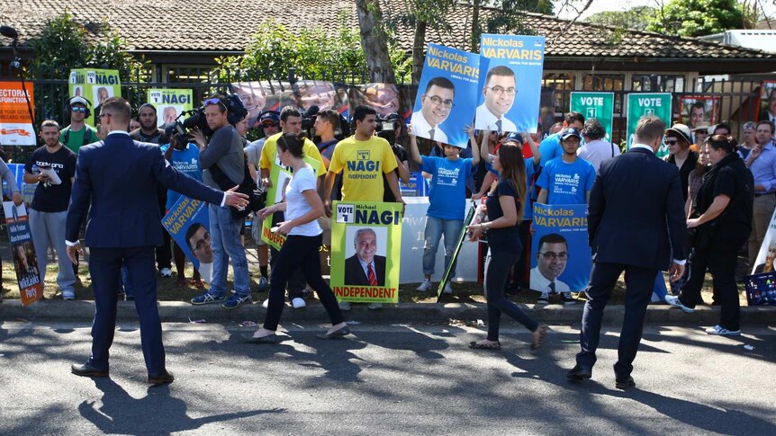 Campaigners from different parties gather on a street