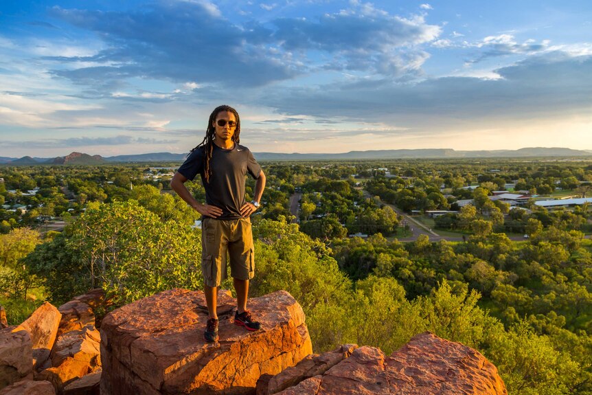 NYT reporter John Eligon stands on a rocky outcrop overlooking Kununurra, Western Australia.