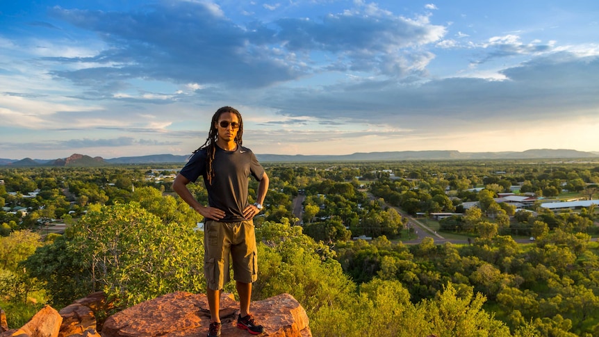 NYT reporter John Eligon stands on a rocky outcrop overlooking Kununurra, Western Australia.