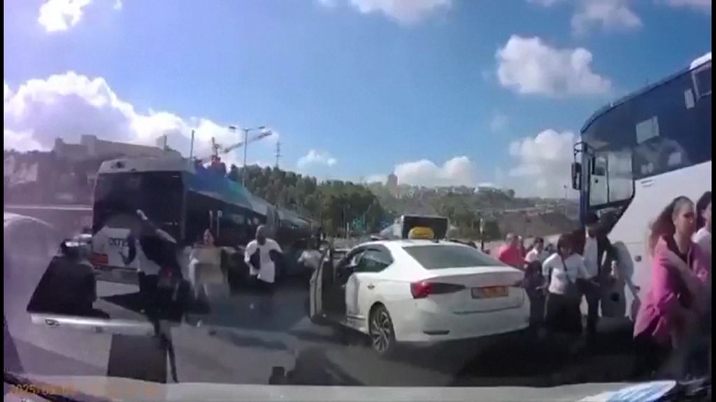 Dashcam video frame shows people running from the scene of a bus shooting in Jerusalem