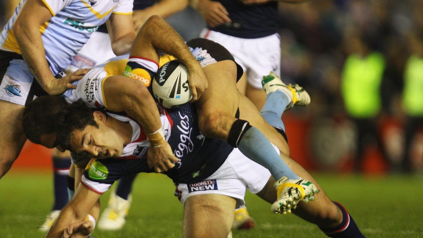 Tight tussle ... Braith Anasta tries to beat the Sharks defence