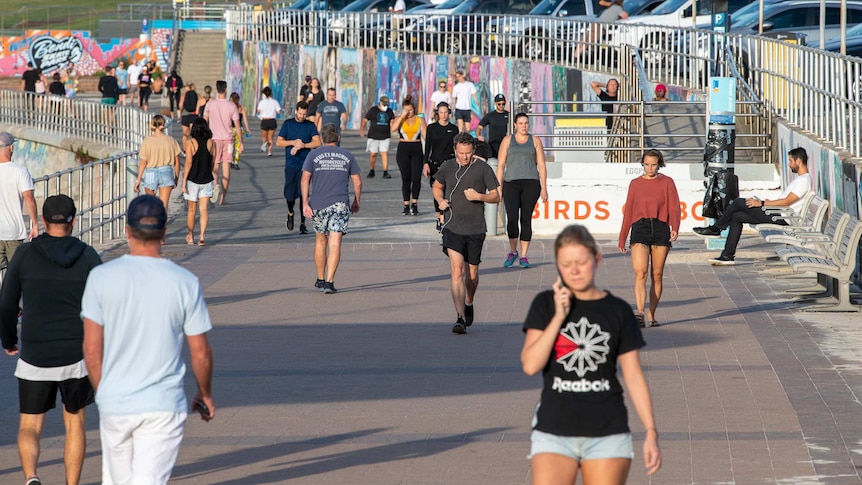 People exercise on the pathway at Bondi Beach in Sydney.