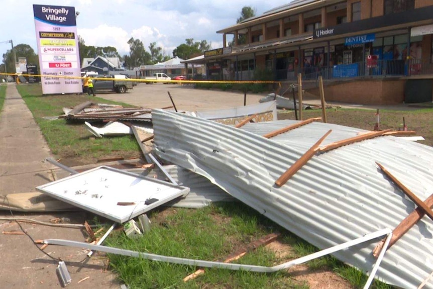 Roofing debris scattered in front of shops